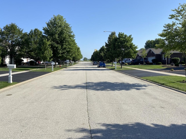 831 Oriole Dr, Peotone, IL 60468 - view of concrete street with street lights, curbs, sidewalks, and a residential view