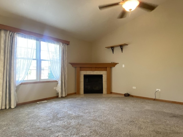 831 Oriole Dr, Peotone, IL 60468 - unfurnished living room featuring carpet floors, lofted ceiling, a tile fireplace, and a ceiling fan
