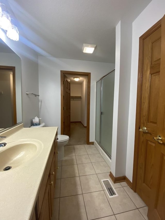 831 Oriole Dr, Peotone, IL 60468 - full bath featuring vanity, a shower stall, tile patterned flooring, and a closet