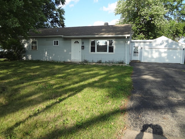 210 Caddy Ave, Carpentersville, IL 60110 - view of front of property featuring asphalt driveway, a front yard, a chimney, and roof with shingles