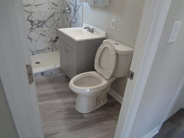 210 Caddy Ave, Carpentersville, IL 60110 - bathroom featuring a stall shower, vanity, and wood finished floors