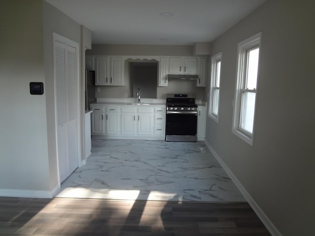 210 Caddy Ave, Carpentersville, IL 60110 - kitchen featuring stainless steel range with gas cooktop, light marble finish flooring, white cabinets, light countertops, and freestanding refrigerator