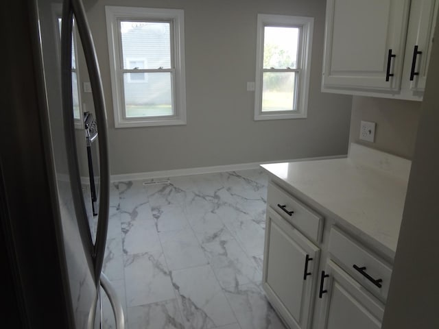 210 Caddy Ave, Carpentersville, IL 60110 - laundry room featuring marble finish floors and cabinet space