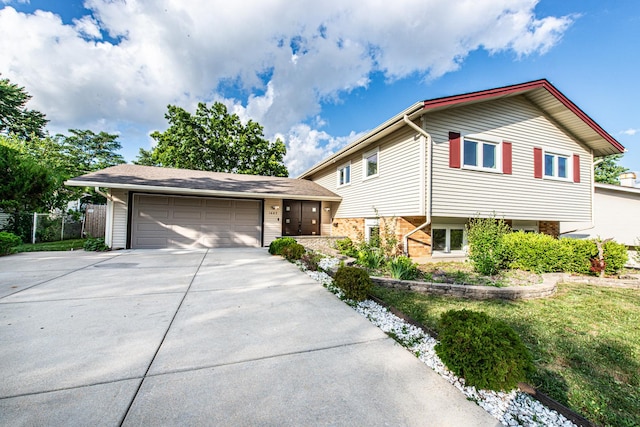 1665 Highland Blvd, Hoffman Estates, IL 60169 - tri-level home with driveway, an attached garage, and brick siding