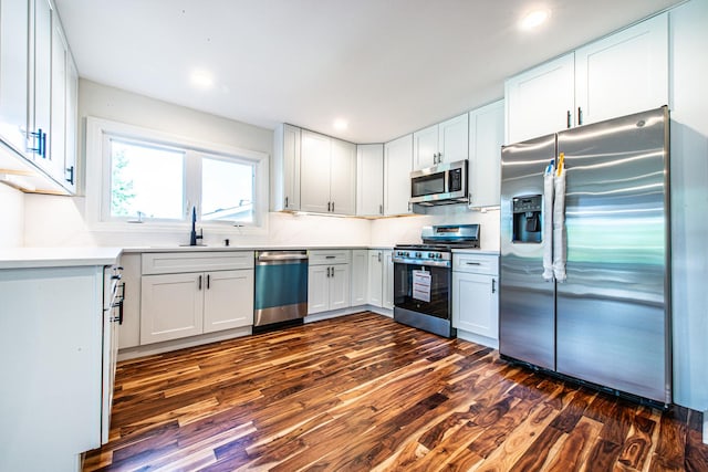1665 Highland Blvd, Hoffman Estates, IL 60169 - kitchen with appliances with stainless steel finishes, dark wood-type flooring, white cabinetry, light countertops, and tasteful backsplash