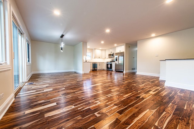 1665 Highland Blvd, Hoffman Estates, IL 60169 - unfurnished living room featuring dark wood-type flooring and recessed lighting