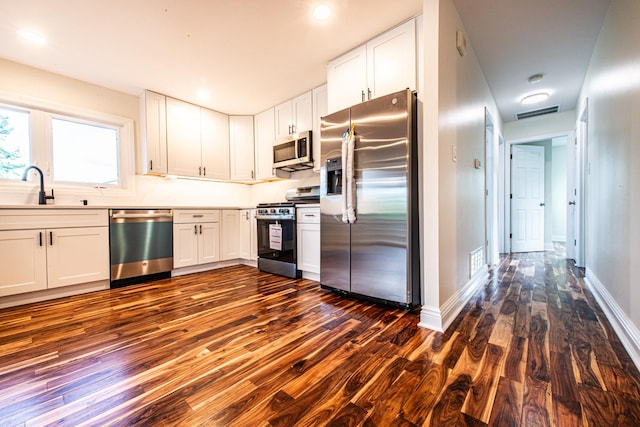 1665 Highland Blvd, Hoffman Estates, IL 60169 - kitchen with appliances with stainless steel finishes, dark wood-style flooring, white cabinets, and light countertops
