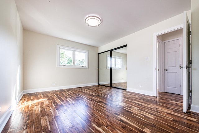 1665 Highland Blvd, Hoffman Estates, IL 60169 - unfurnished bedroom with dark wood-style floors and a closet