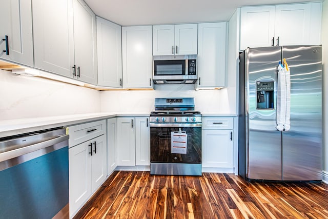 1665 Highland Blvd, Hoffman Estates, IL 60169 - kitchen featuring appliances with stainless steel finishes, dark wood-style floors, light countertops, and white cabinets