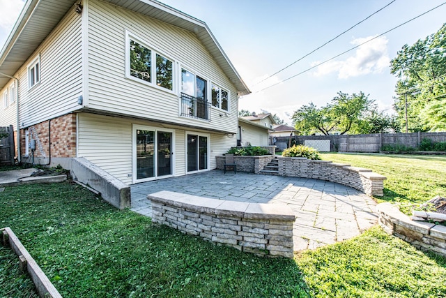 1665 Highland Blvd, Hoffman Estates, IL 60169 - back of property with brick siding, a patio area, and a fenced backyard