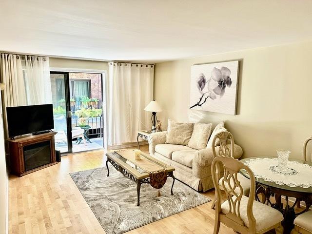 2317 N Neva Ave Unit 106A, Chicago, IL 60707 - living room featuring light wood-style flooring