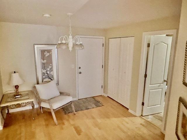 2317 N Neva Ave Unit 106A, Chicago, IL 60707 - foyer featuring a chandelier and light wood-style flooring