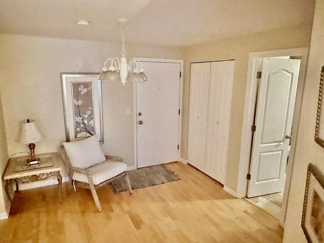 2317 N Neva Ave Unit 106A, Chicago, IL 60707 - foyer entrance with light wood-type flooring and a chandelier