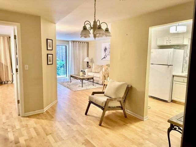 2317 N Neva Ave Unit 106A, Chicago, IL 60707 - sitting room featuring a chandelier and light wood finished floors