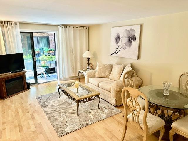 2317 N Neva Ave Unit 106A, Chicago, IL 60707 - living room featuring wood finished floors