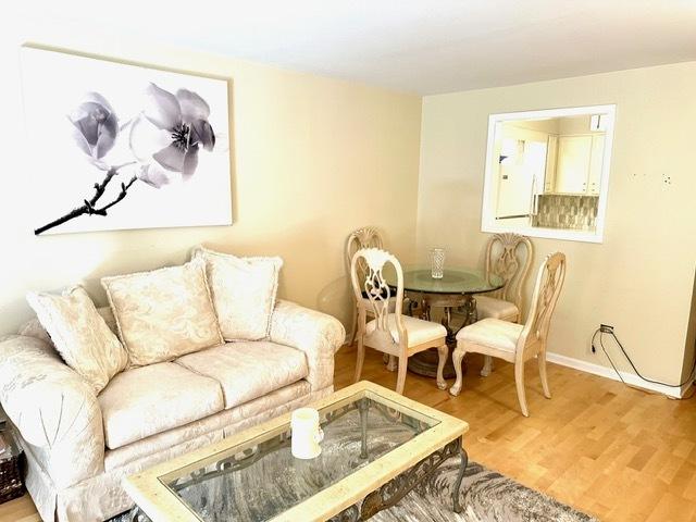 2317 N Neva Ave Unit 106A, Chicago, IL 60707 - living area featuring wood finished floors and baseboards