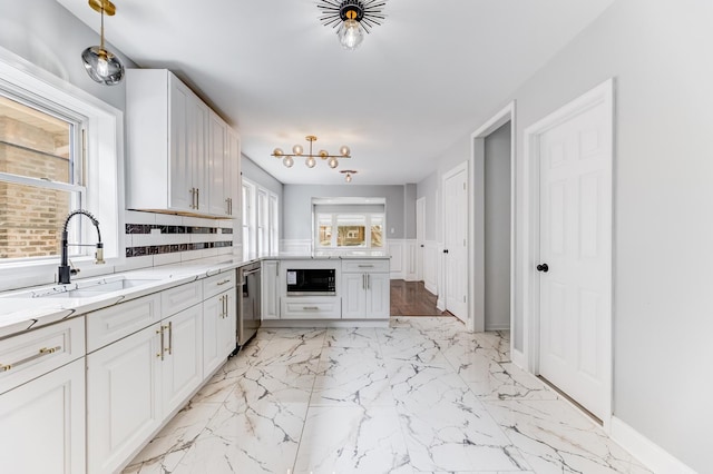 8109 S Marquette Ave, Chicago, IL 60617 - kitchen with built in microwave, light marble finish floors, a peninsula, light stone countertops, and dishwasher