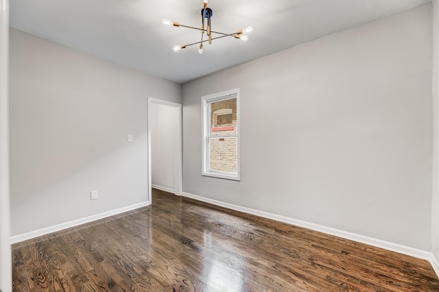 8109 S Marquette Ave, Chicago, IL 60617 - empty room featuring a chandelier and dark wood-type flooring