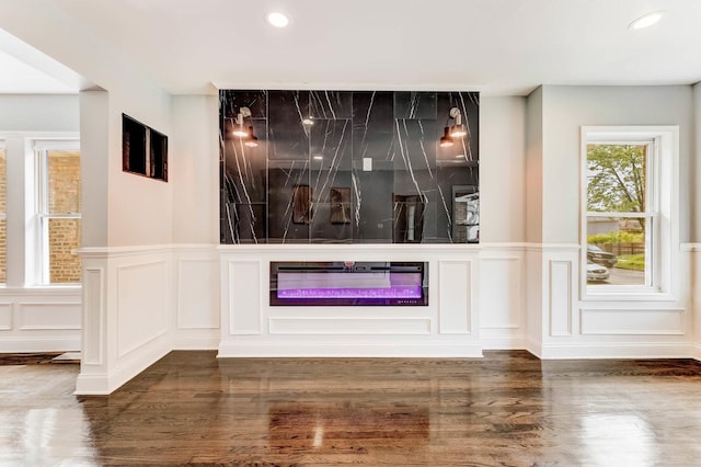 8109 S Marquette Ave, Chicago, IL 60617 - unfurnished living room with a decorative wall, recessed lighting, wood finished floors, a glass covered fireplace, and a wainscoted wall