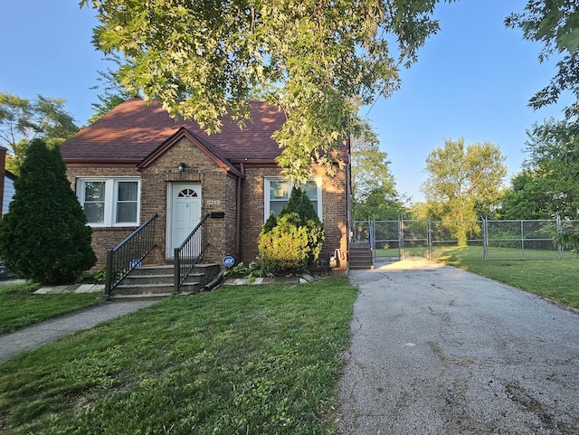 14931 Riverside Dr, South Holland, IL 60473 - view of front of house featuring brick siding, driveway, a gate, and roof with shingles