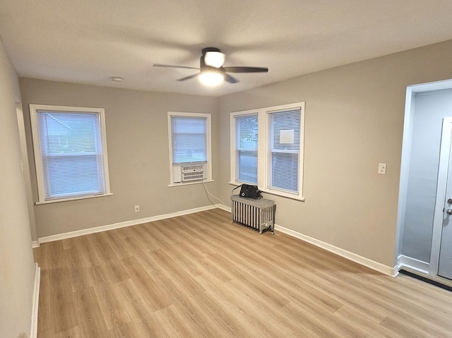 14931 Riverside Dr, South Holland, IL 60473 - empty room with ceiling fan, wood finished floors, radiator heating unit, and a smoke detector