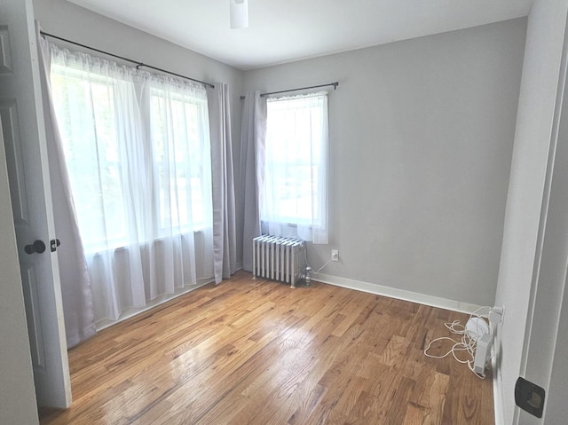 14931 Riverside Dr, South Holland, IL 60473 - empty room with radiator heating unit and wood finished floors