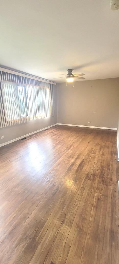 9236 Stanford Dr S, Bridgeview, IL 60455 - unfurnished room featuring wood finished floors and a ceiling fan