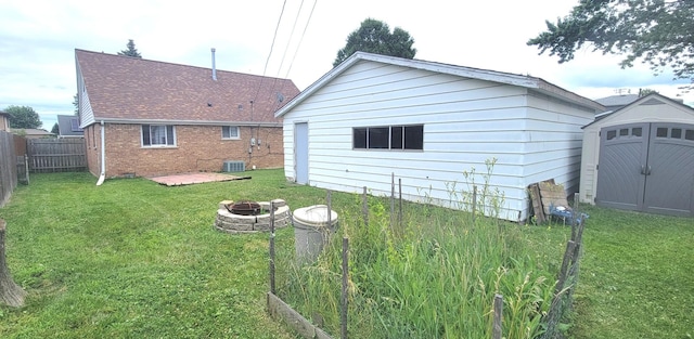 9236 Stanford Dr S, Bridgeview, IL 60455 - back of house with a fire pit, a storage shed, and brick siding