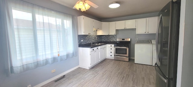 9236 Stanford Dr S, Bridgeview, IL 60455 - kitchen with appliances with stainless steel finishes, dark countertops, tasteful backsplash, and light wood-style floors