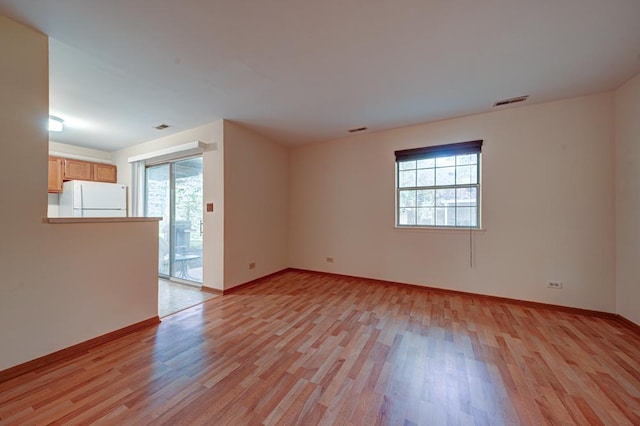 556 E Shagbark Ln Unit C, Streamwood, IL 60107 - unfurnished room with healthy amount of natural light and light wood-type flooring