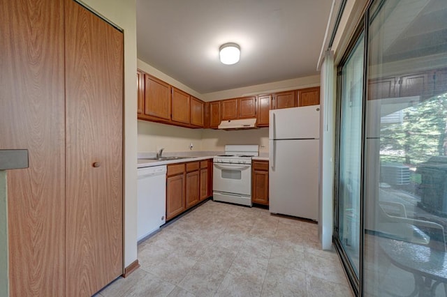 556 E Shagbark Ln Unit C, Streamwood, IL 60107 - kitchen with white appliances, under cabinet range hood, light countertops, and brown cabinetry