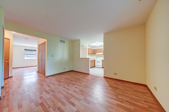 556 E Shagbark Ln Unit C, Streamwood, IL 60107 - unfurnished living room featuring light wood-style floors and baseboards