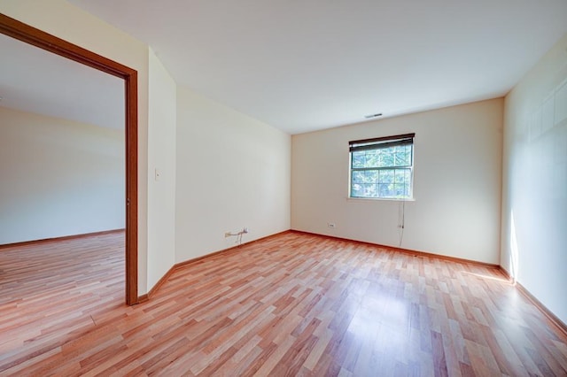 556 E Shagbark Ln Unit C, Streamwood, IL 60107 - spare room featuring light wood finished floors and baseboards