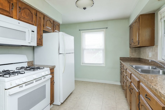 950 Pennsylvania Ave, Aurora, IL 60506 - kitchen with white appliances, brown cabinetry, decorative backsplash, and light tile patterned flooring