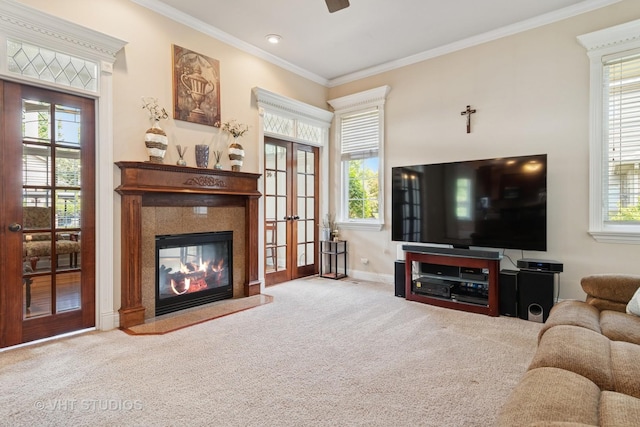 12840 Shenandoah Trl, Plainfield, IL 60585 - carpeted living room featuring plenty of natural light, crown molding, a glass covered fireplace, french doors, and ceiling fan