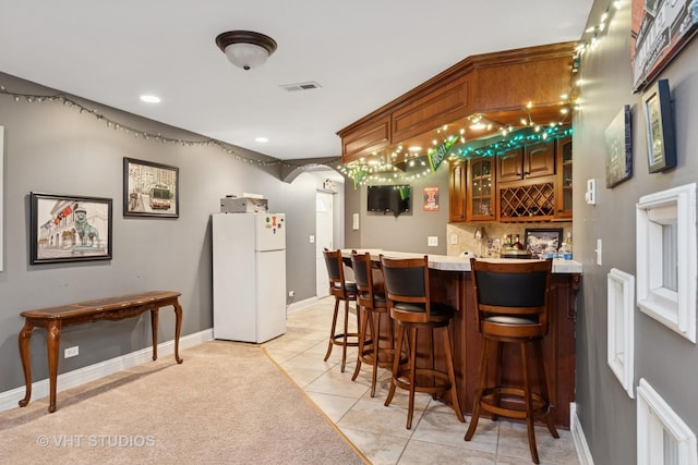 12840 Shenandoah Trl, Plainfield, IL 60585 - indoor wet bar featuring freestanding refrigerator, light tile patterned flooring, recessed lighting, and decorative backsplash