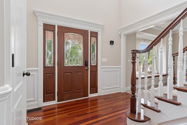12840 Shenandoah Trl, Plainfield, IL 60585 - foyer entrance featuring wood finished floors, stairs, a decorative wall, wainscoting, and a towering ceiling