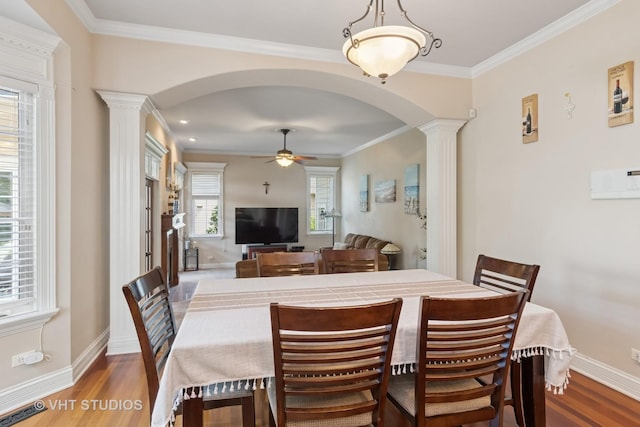 12840 Shenandoah Trl, Plainfield, IL 60585 - dining area with decorative columns, arched walkways, wood finished floors, and ornamental molding