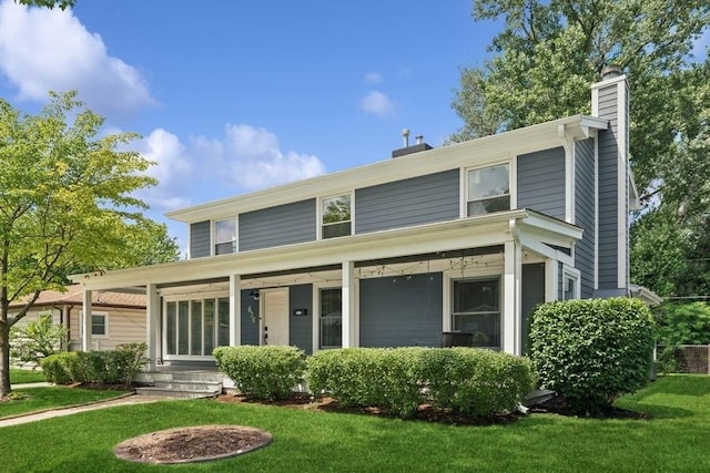 636 N Greenview Ave, Mundelein, IL 60060 - view of front facade with a chimney, a front yard, and a porch