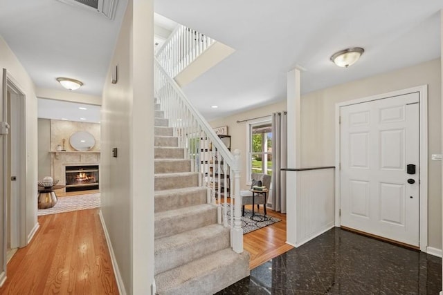 636 N Greenview Ave, Mundelein, IL 60060 - foyer entrance featuring a warm lit fireplace, granite floors, and stairs
