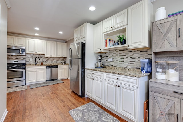 37369 N Loretto Ave, Lake Villa, IL 60046 - kitchen featuring appliances with stainless steel finishes, decorative backsplash, light wood-type flooring, recessed lighting, and light stone countertops