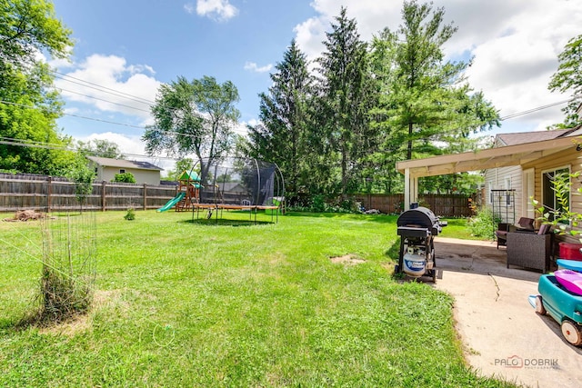37369 N Loretto Ave, Lake Villa, IL 60046 - fenced backyard featuring a trampoline, a playground, and a patio area