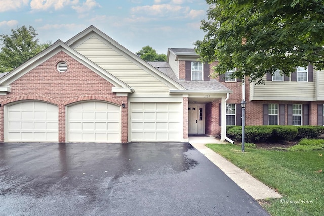 1620 Hadley Ct Unit A2, Wheeling, IL 60090 - view of front facade featuring brick siding, driveway, a garage, and roof with shingles