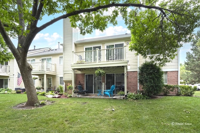 1620 Hadley Ct Unit A2, Wheeling, IL 60090 - rear view of property with brick siding, a balcony, a chimney, and a lawn