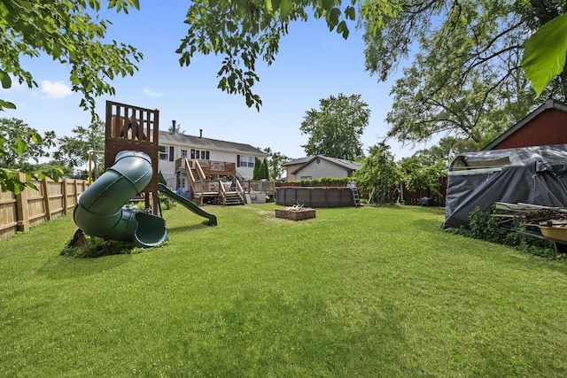10302 W Palmer Ave, Melrose Park, IL 60164 - fenced backyard featuring a playground and a fire pit