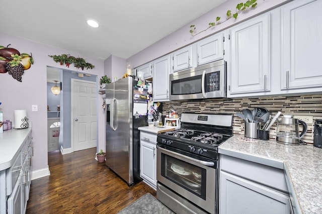 10302 W Palmer Ave, Melrose Park, IL 60164 - kitchen featuring appliances with stainless steel finishes, backsplash, white cabinetry, dark wood-style flooring, and tile counters