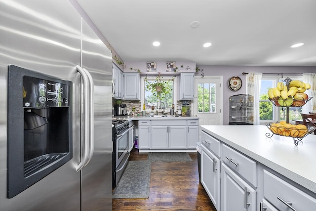 10302 W Palmer Ave, Melrose Park, IL 60164 - kitchen featuring stainless steel appliances, light countertops, dark wood finished floors, recessed lighting, and white cabinetry