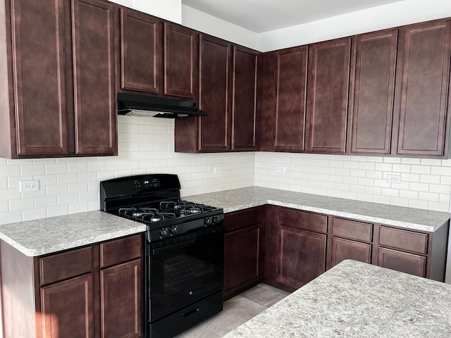 4219 Chelsea Manor Cir, Aurora, IL 60504 - kitchen featuring black gas range, under cabinet range hood, light countertops, and decorative backsplash