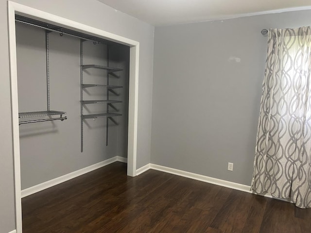 308 S 5th Ave, Streator, IL 61364 - unfurnished bedroom with dark wood finished floors and a closet
