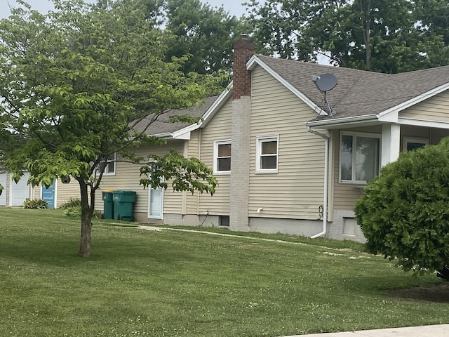 308 S 5th Ave, Streator, IL 61364 - view of side of property with a chimney, a lawn, and a shingled roof